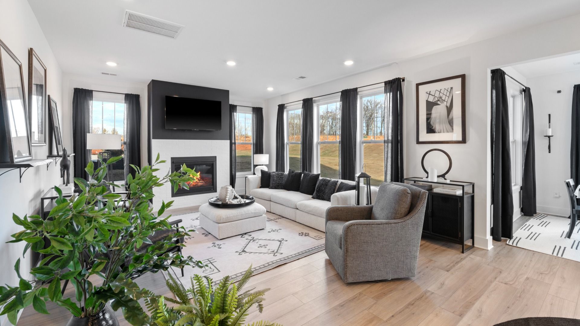 Spacious family room with rich hardwood flooring and elegant trim work in a reputable DRB Homes build