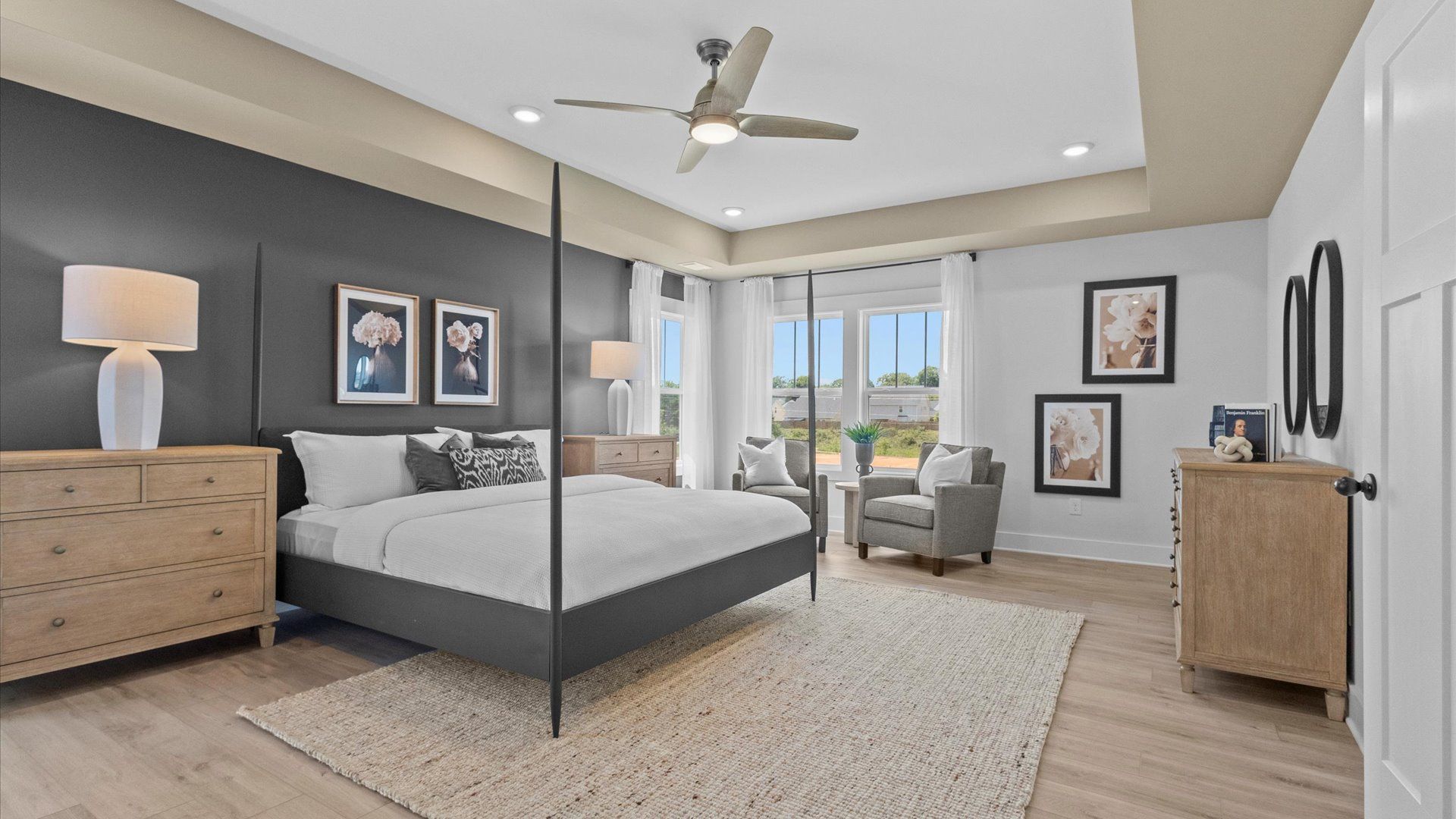 Elegant primary suite with tray ceiling and walk-in closet in this top-notch Woodland Summit home