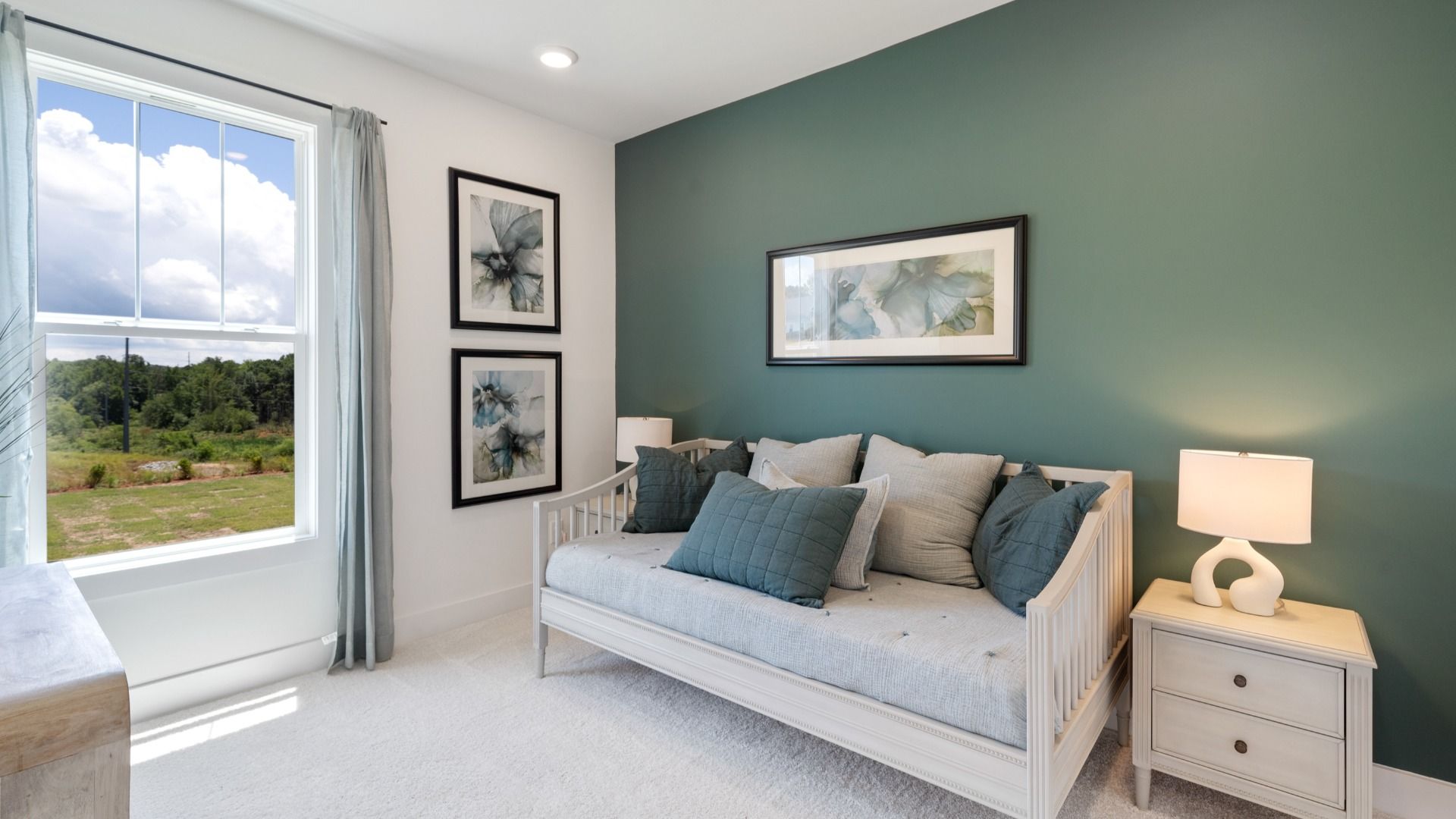 Secondary bedroom at Magnolia Park with green accent wall and plush carpet in Woodruff, SC by DRB Homes