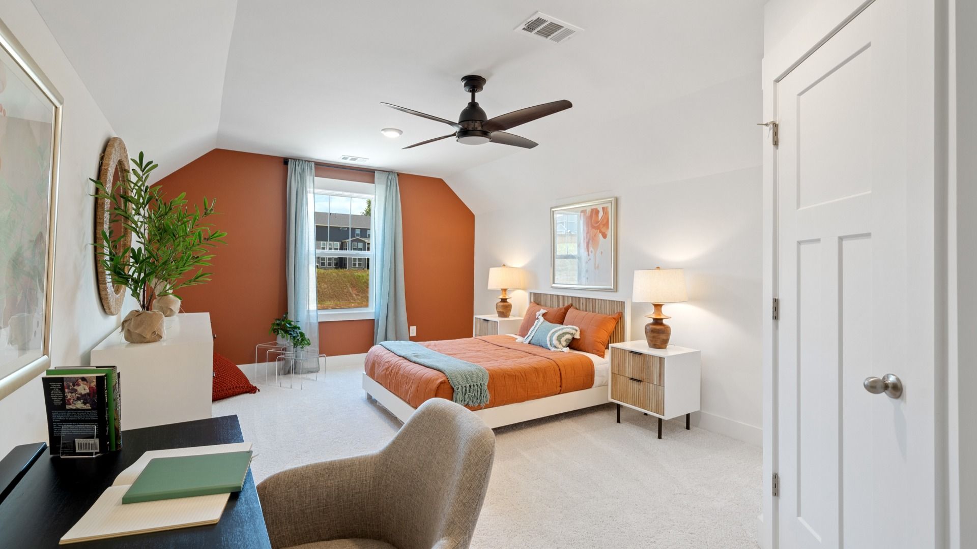 Elevated ceiling bonus room with plush carpet, ceiling fan, and large window at Magnolia Park by DRB Homes in Woodruff, SC