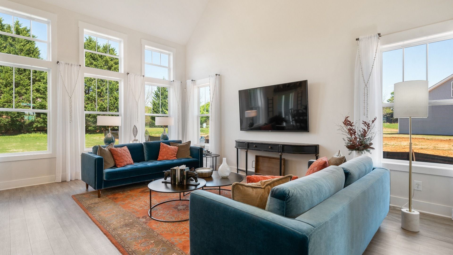 Tasteful family room with two-story volume, refined finishes, and exceptional natural light in Woodruff, SC