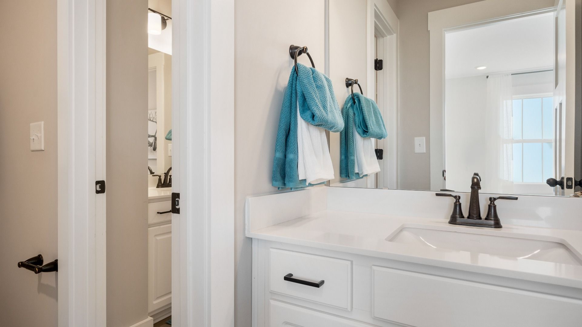 Top-notch bathroom with current fixtures, tasteful materials, and elevated charm at the Wells Crossing community