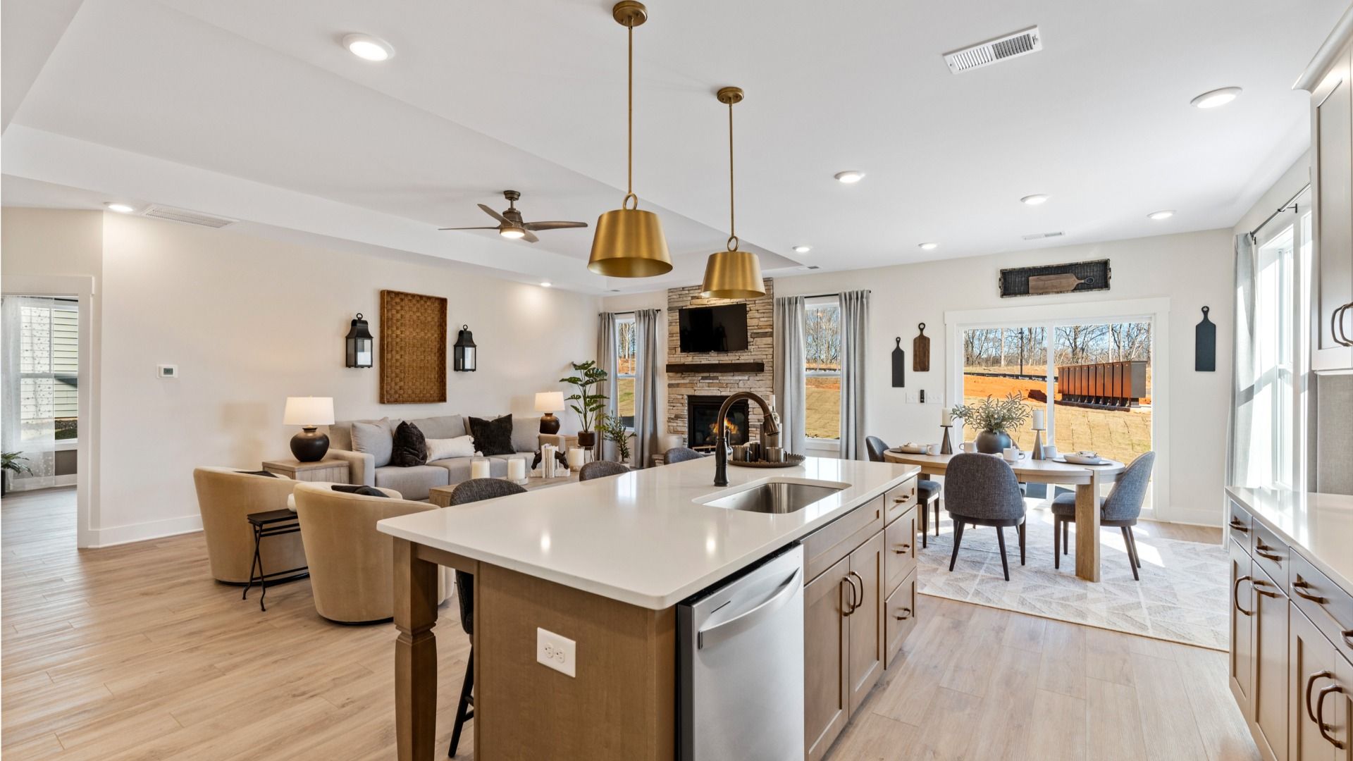 Modern luxury kitchen with gold accents, wood island, and white countertops at Fox Hollow in Spartanburg, SC