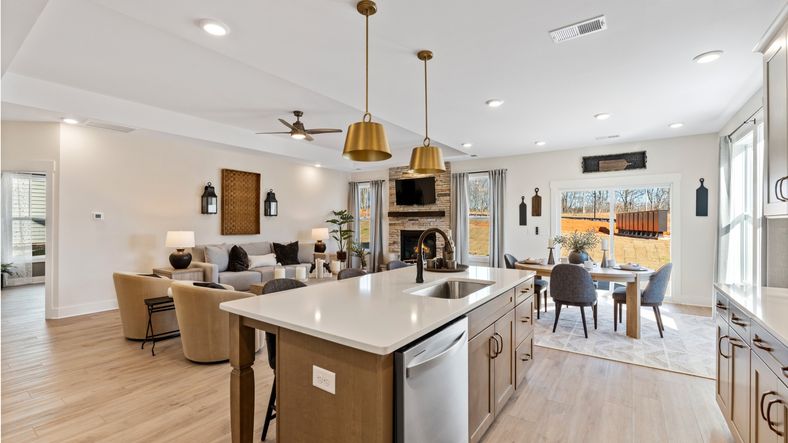 Modern luxury kitchen with gold accents, wood island, and white countertops at Fox Hollow in Spartanburg, SC