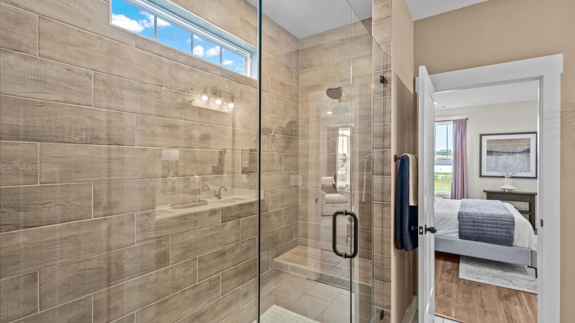 Highly functional and elegant en-suite with dual vanities, tiled walk-in shower, and refined finishes