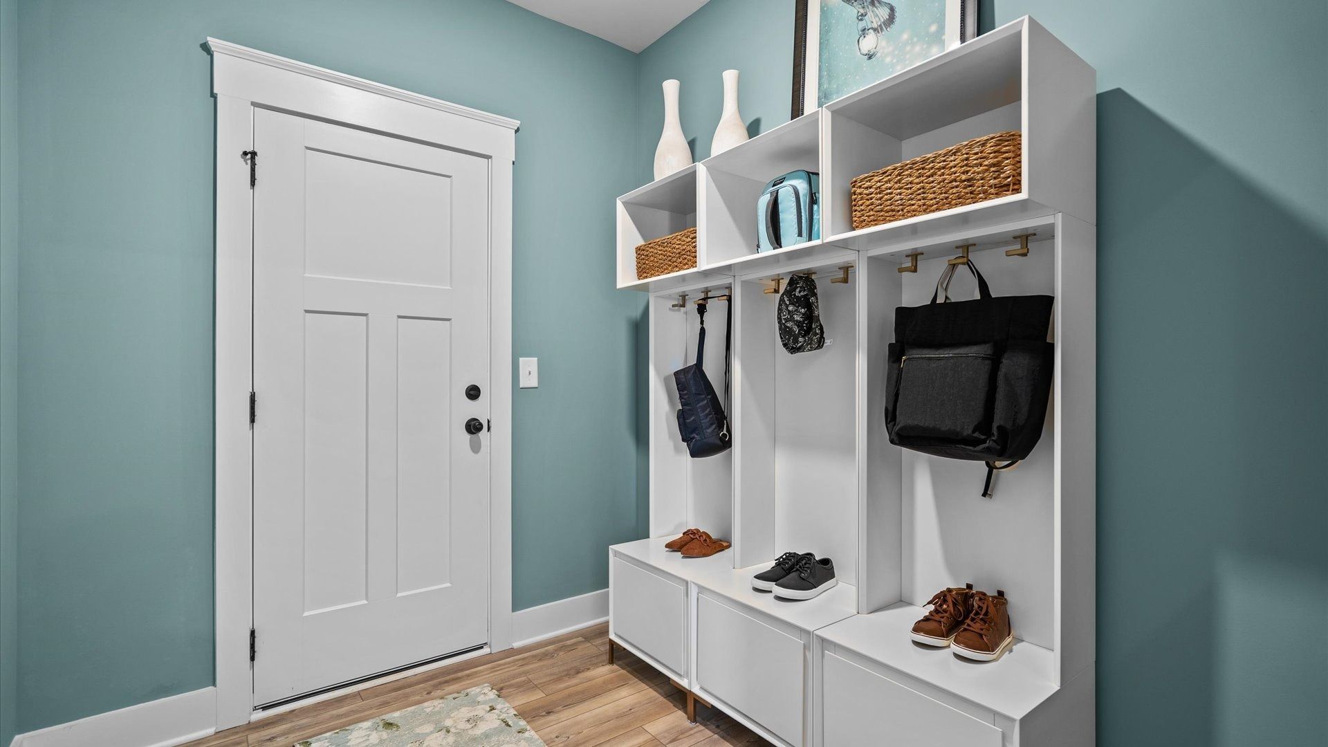 Garage entry mudroom with hardwood flooring at Kayfield at Midway by DRB Homes in Anderson, SC