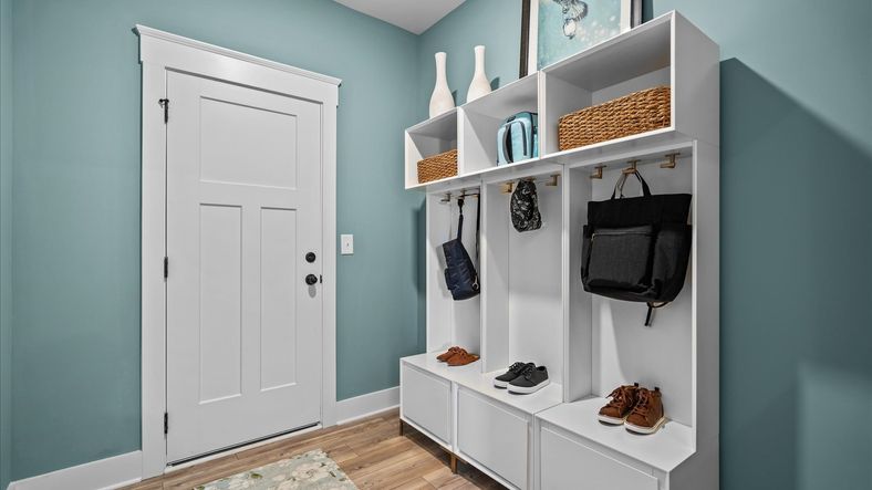 Garage entry mudroom with hardwood flooring at Kayfield at Midway by DRB Homes in Anderson, SC