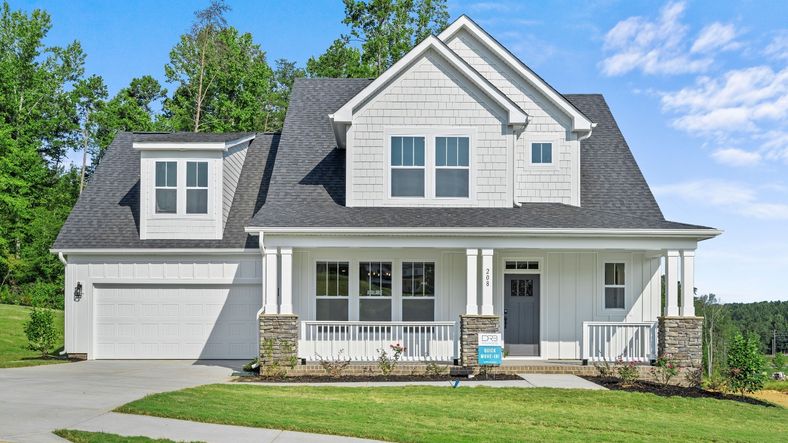 Beautiful white exterior home with front porch at Kayfield at Midway by DRB Homes in Anderson, SC
