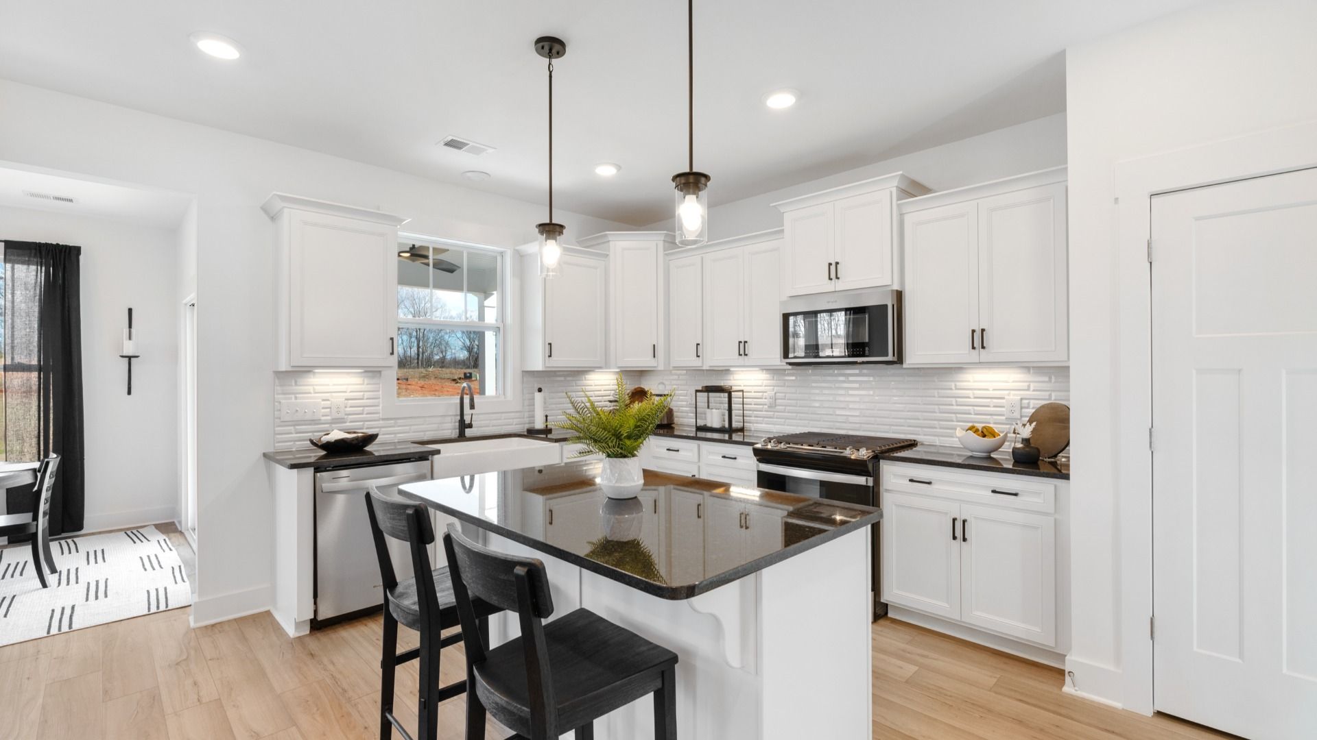 Black and white kitchen with granite countertops at Mulberry Estates by DRB Homes in Simpsonville, South Carolina