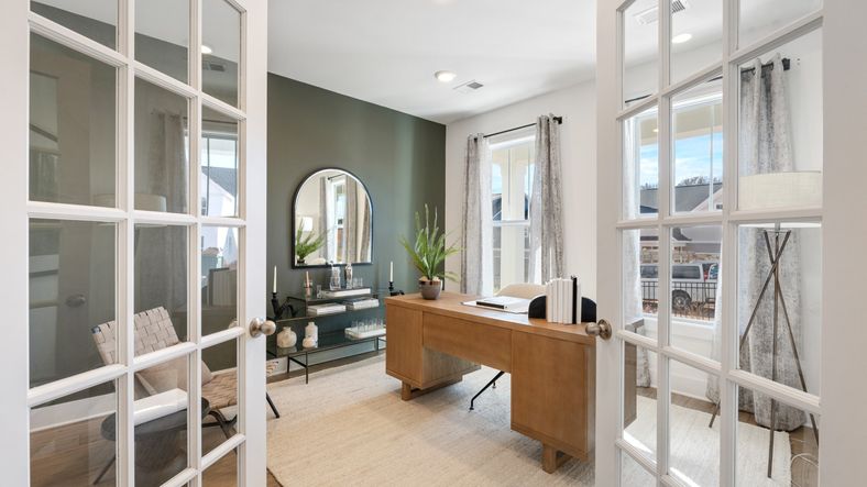 Green accent wall study with french doors at Mulberry Estates by DRB Homes in Simpsonville, South Carolina
