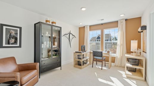 Cozy secondary bedroom with warm toned accent wall and plush carpet with elevated ceilings at Pleasant Falls in Moore, SC
