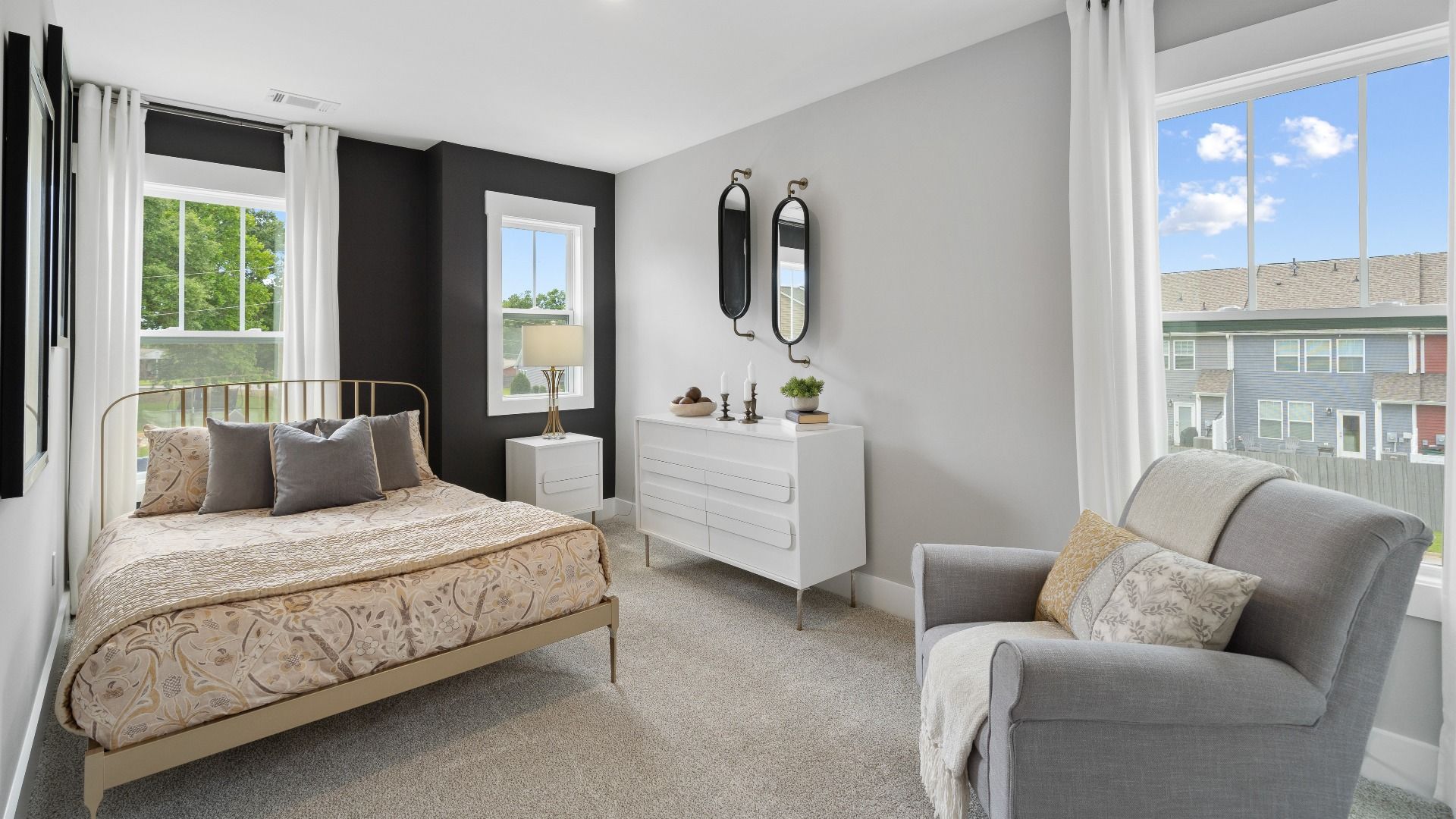 Plush carpeted secondary bedroom with elevated ceilings and large windows at Tyger Ridge by DRB Homes