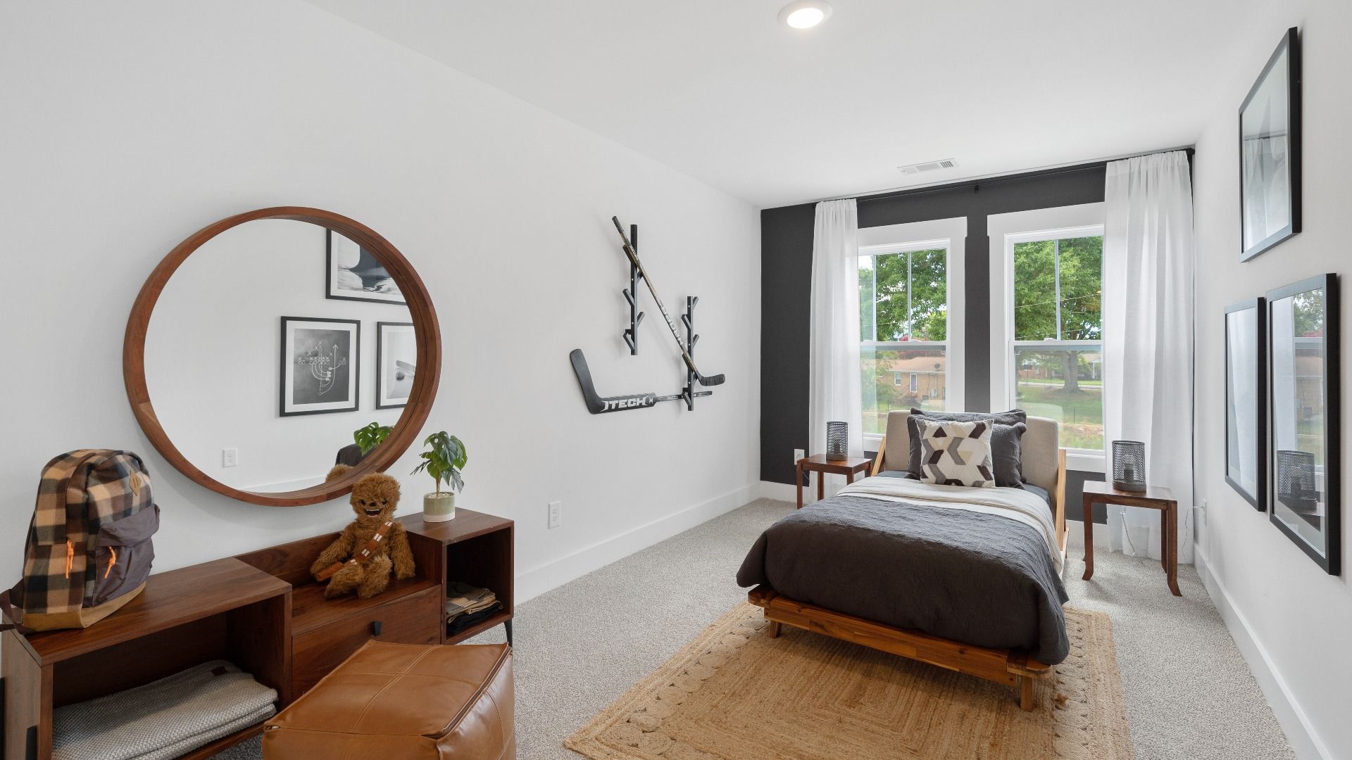 Carpeted secondary bedroom with large windows at Tyger Ridge by DRB Homes in Spartanburg, SC