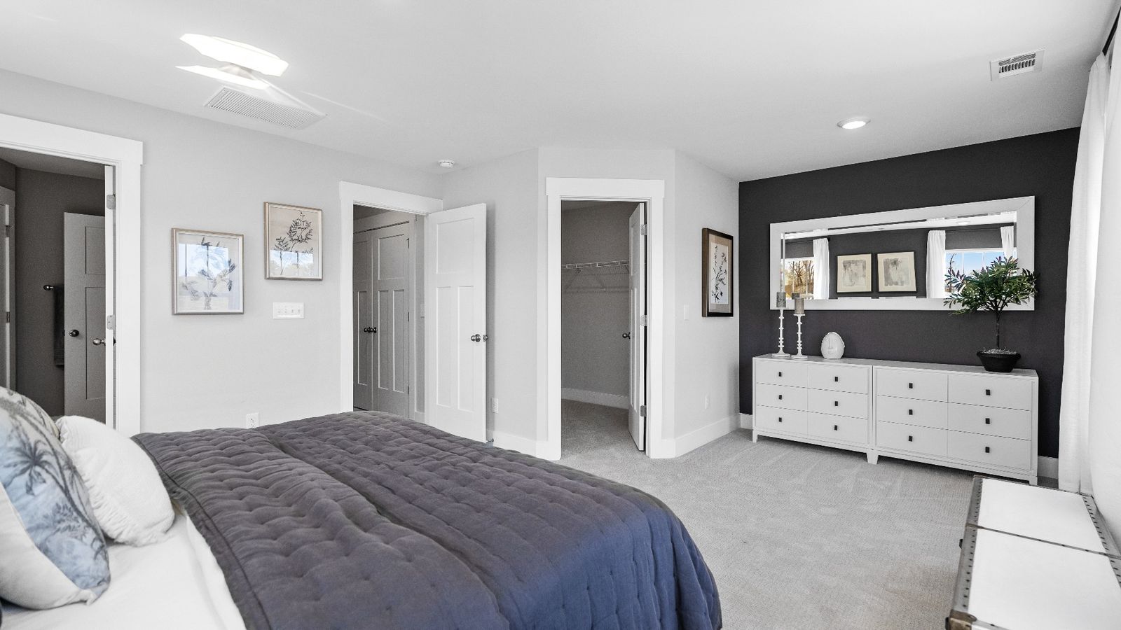 Cozy primary suite with large windows and plush carpets at Hickory Heights by DRB Homes near Downtown Greenville, SC