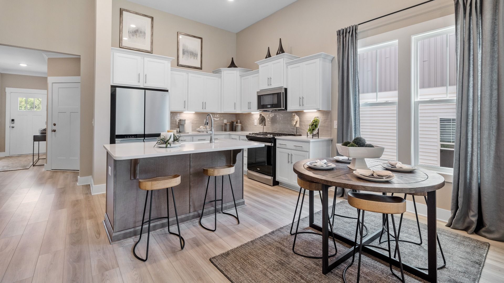 DRB Homes Summit floorplan kitchen with adjacent breakfast area plus island with room for counter stools at Pleasant Falls