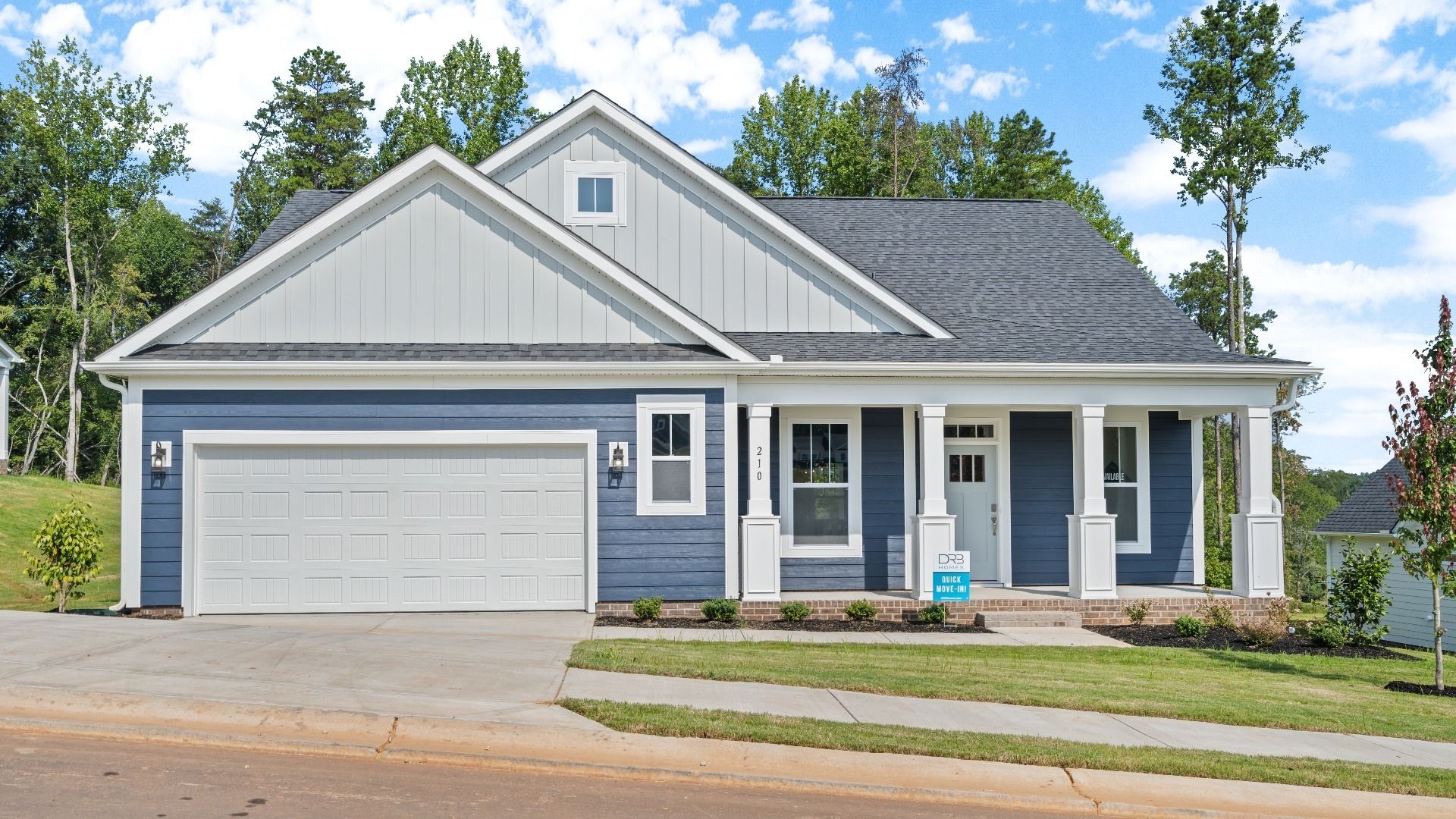 New ranch home with two car garage and dark blue exterior at Pinebrook by DRB Homes in Woodruff, SC