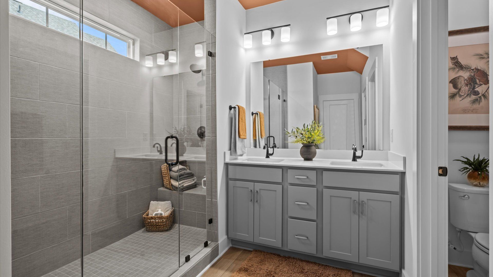Ranch style home with stunning primary bathroom with frameless walk-in tiled shower, double sink vanity, and modern finishes