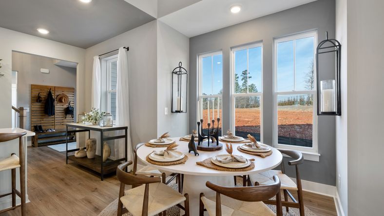 Breakfast room at Village at Midway by DRB Homes in Anderson, SC with trendy decor, LVP flooring, large windows and trim