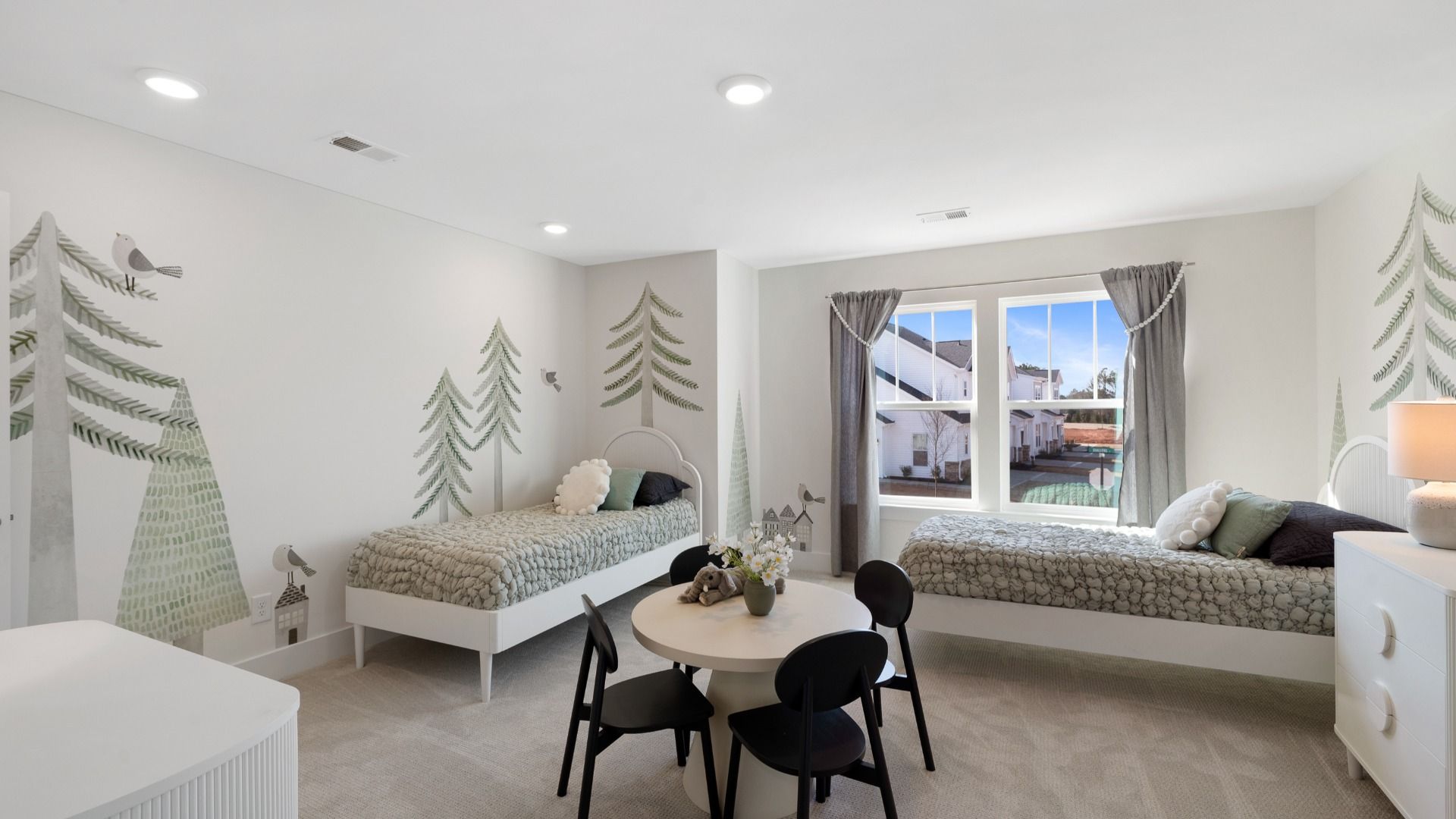 Childs room with nature wall paper, small single beds, tea table and natural finishes at Village at Midway by DRB Homes