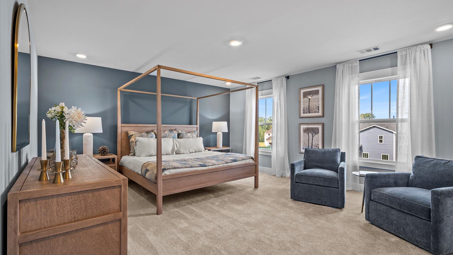 Plush carpeted, large primary suite with large windows and overhead lighting in two story home at DRB Homes in Easley, SC