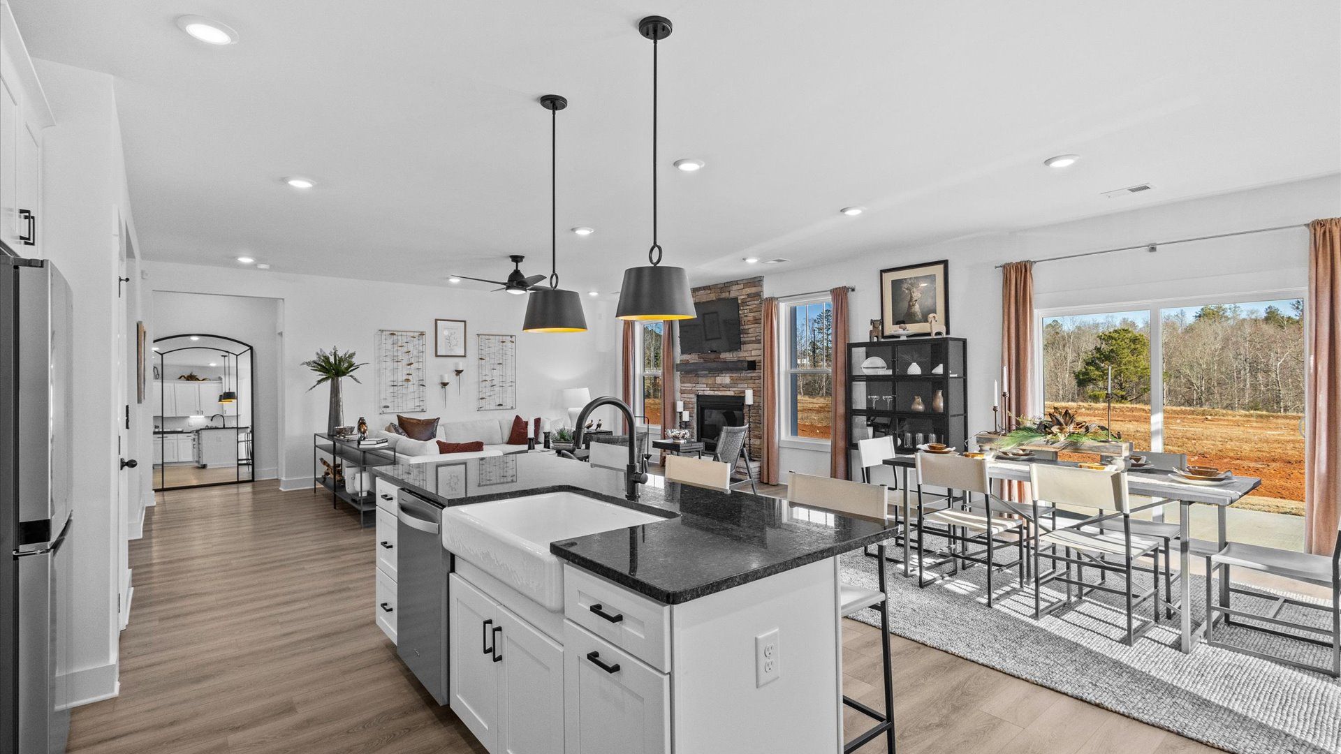 New home at DRB Homes' Wells Crossing with modern, black accented kitchen with large white island in Seneca, SC