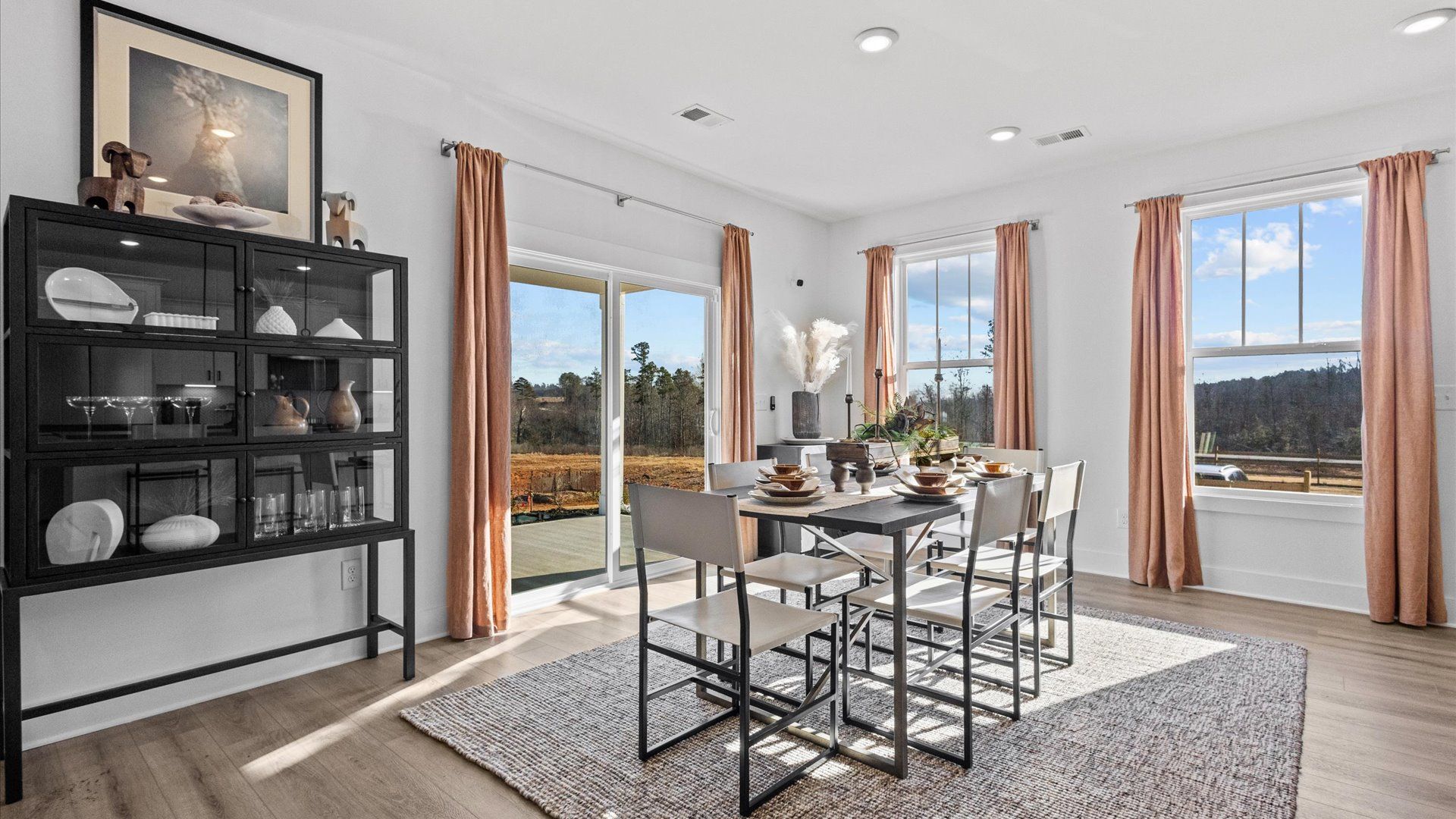 Modern breakfast area with black accents and large windows at Wells Crossing by DRB Homes in Seneca, SC