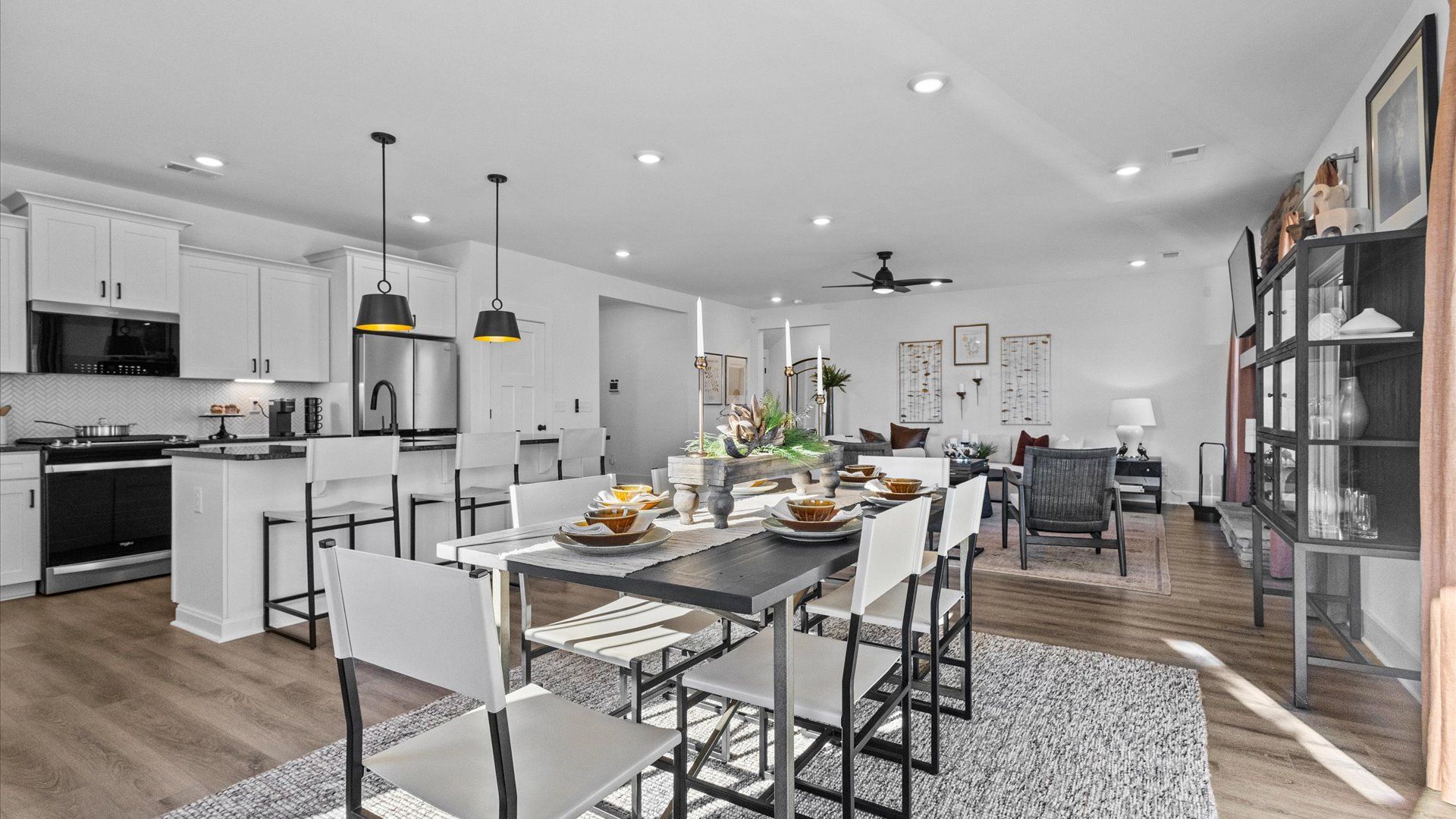 Black and white, modern breakfast area with hardwood flooring and elevated ceilings at Wells Crossing by DRB Homes