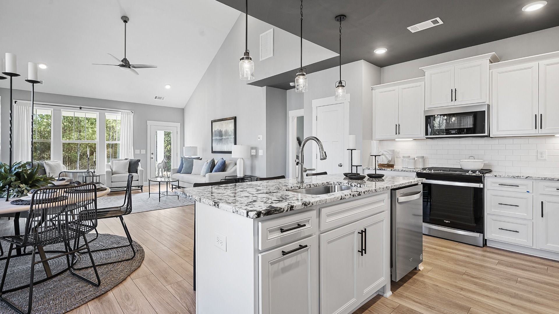Kitchen with whirlpool appliances, modern accents, crown molding and granite countertops in Anderson, SC by DRB Homes