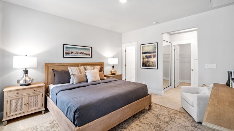 Primary bedroom with en suite bathroom, elevated ceilings, and hardwood flooring at Aspen Ridge by DRB Homes in Lyman, SC
