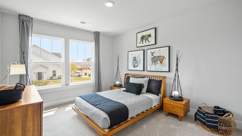Large secondary bedroom with carpet and large windows at Aspen Ridge by DRB Homes in Lyman, SC