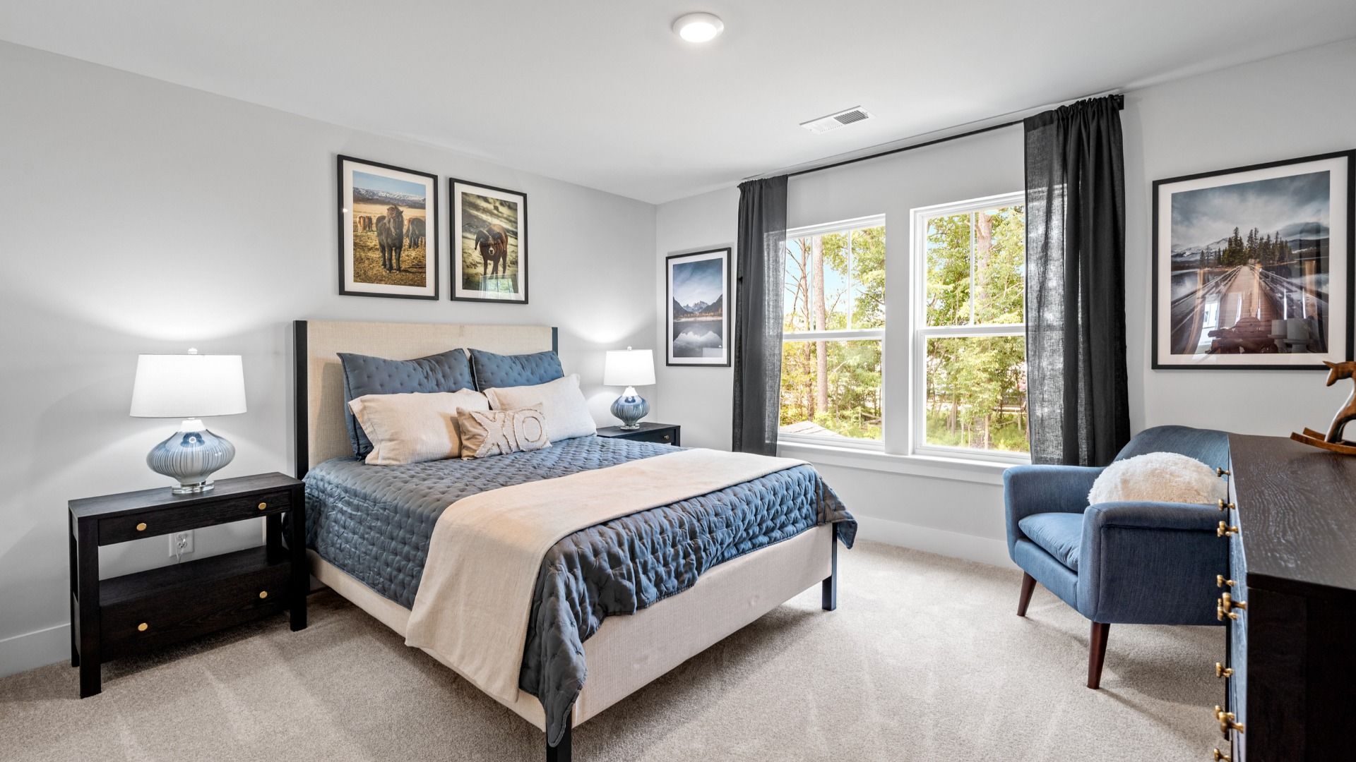 Cozy secondary bedroom with carpeted flooring, light colored walls, and large windows at Aspen Ridge in Lyman, SC