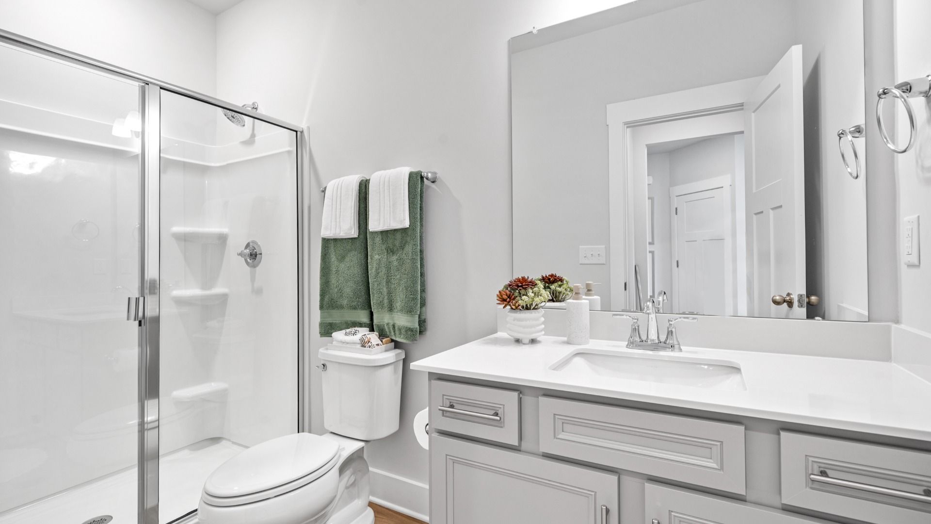 Elegant bathroom with polished details, walk-in shower, and large vanity at Aspen Ridge by DRB Homes