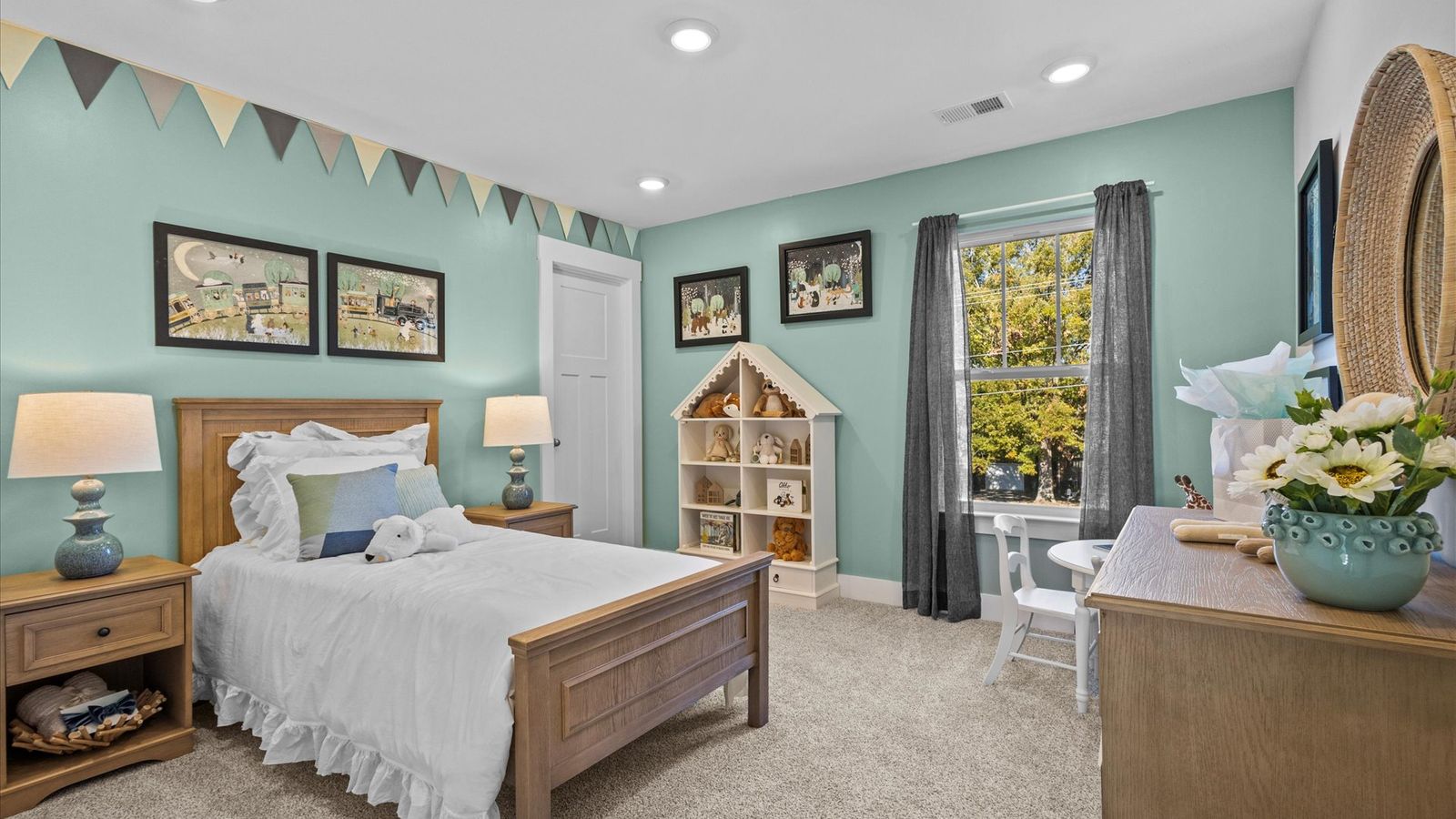Child's bedroom with outdoorsy theme, bright blue walls, elevated ceilings, and plush carpet in Mint floorplan by DRB Homes
