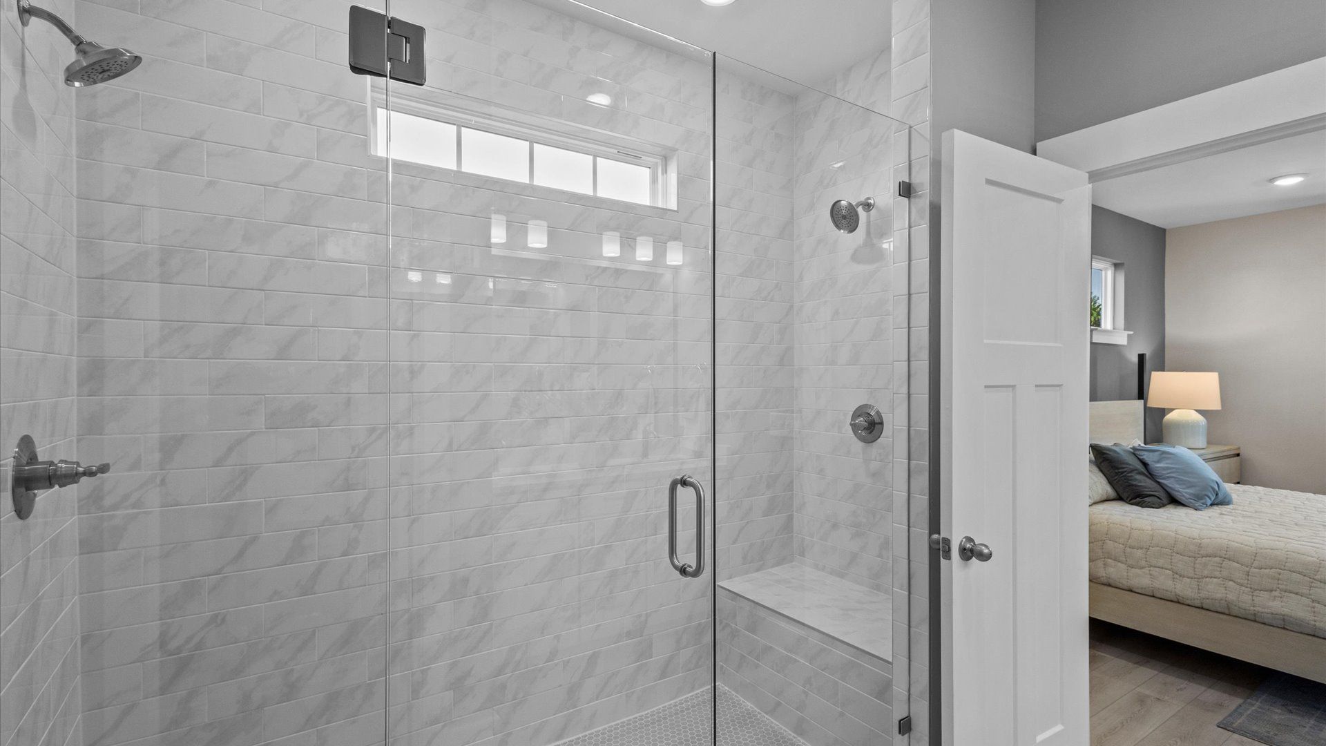 Elegant gray and white marble tile walk-in shower with glass door in Mint floorplan at Pleasant Falls in Moore, SC