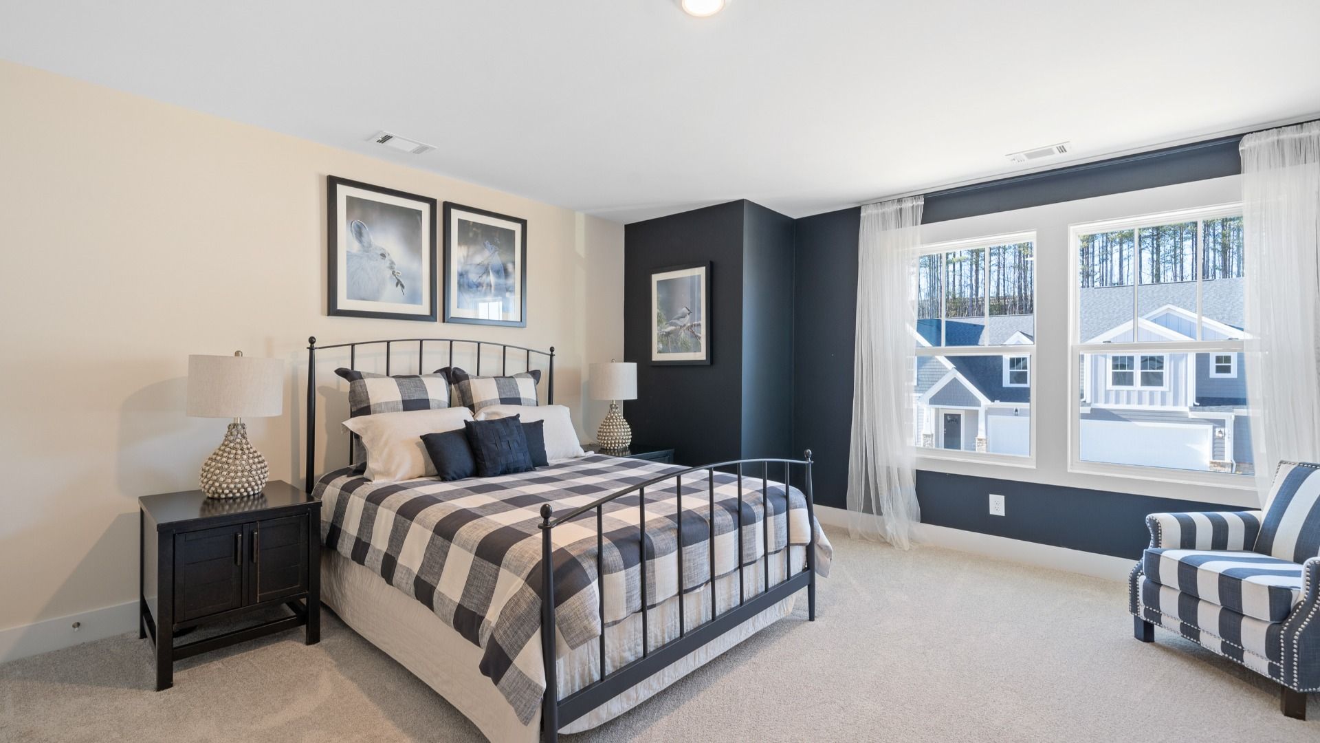 Secondary bedroom with dark accent wall, plush carpet, and large windows patterned decor at Village at Midway in Anderson, SC