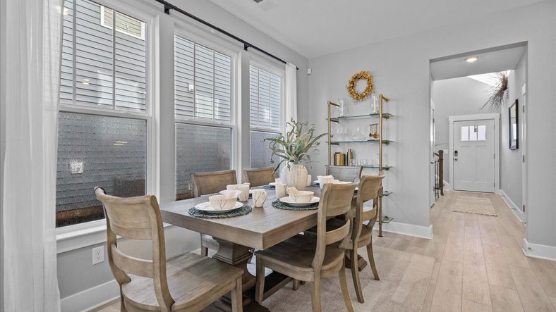 Breakfast nook in Mint floorplan by DRB Homes with bay of windows and hardwood floors at Pleasant Falls in Moore, SC