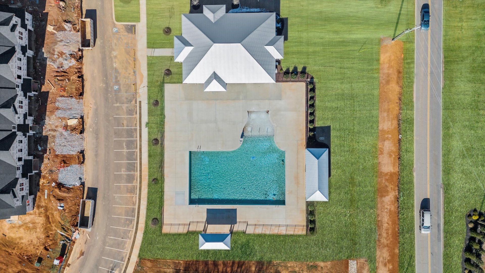 Large amenities center including resort style swimming pool at Village at Midway by DRB Homes