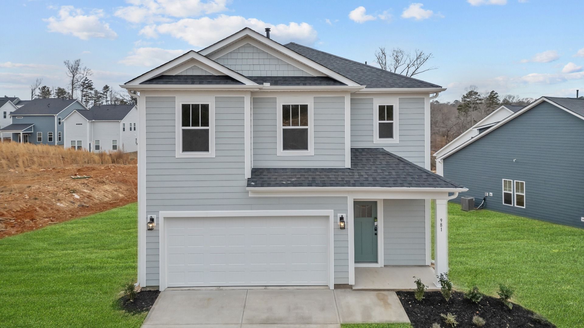 Cool toned exterior two story home with two car garage at Pleasant Falls by DRB Homes in Moore, SC