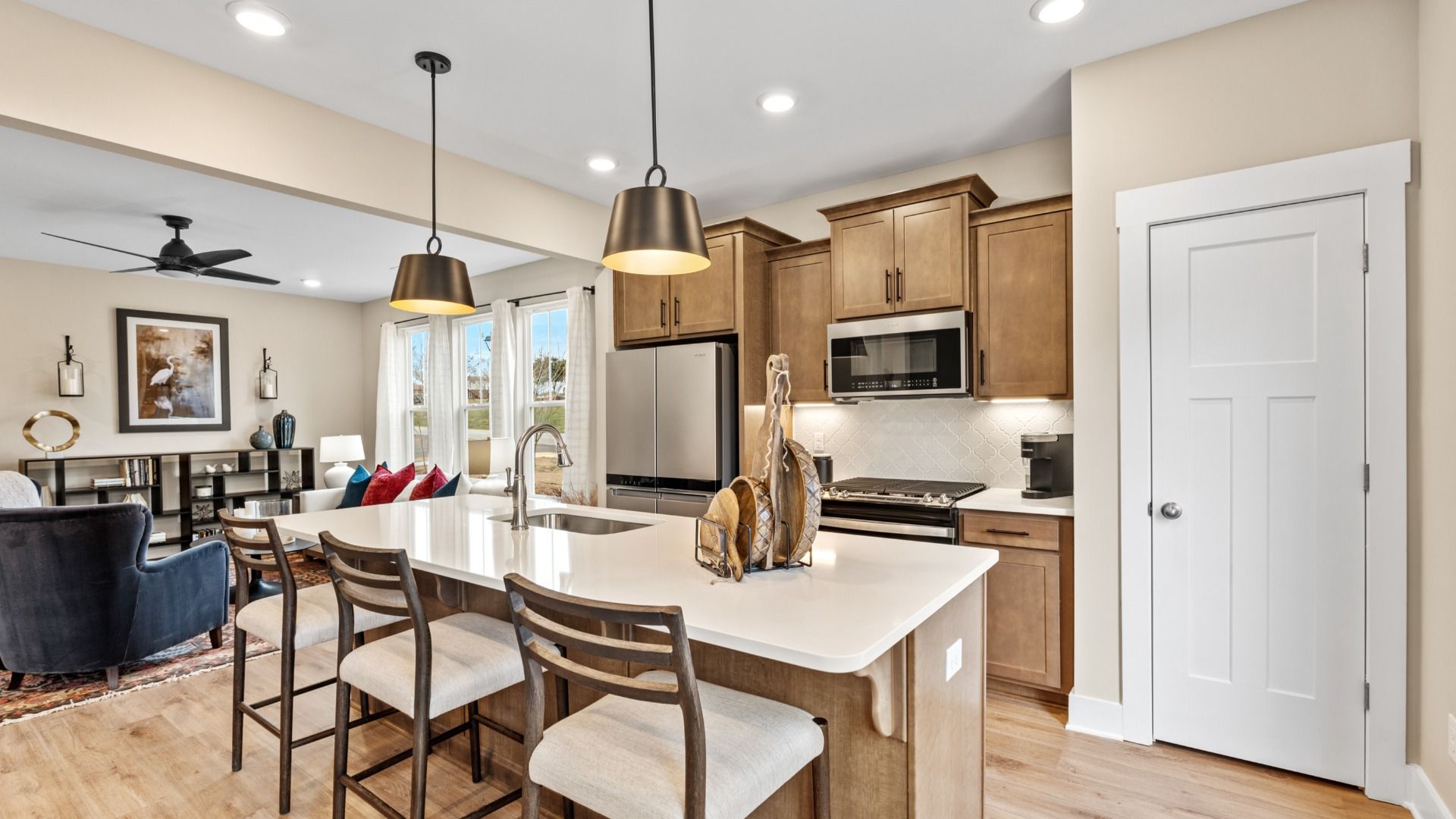 Wooden cabinetry kitchen with white quartz countertops in two story townhome at Saluda Crossing by DRB Homes in Piedmont, SC