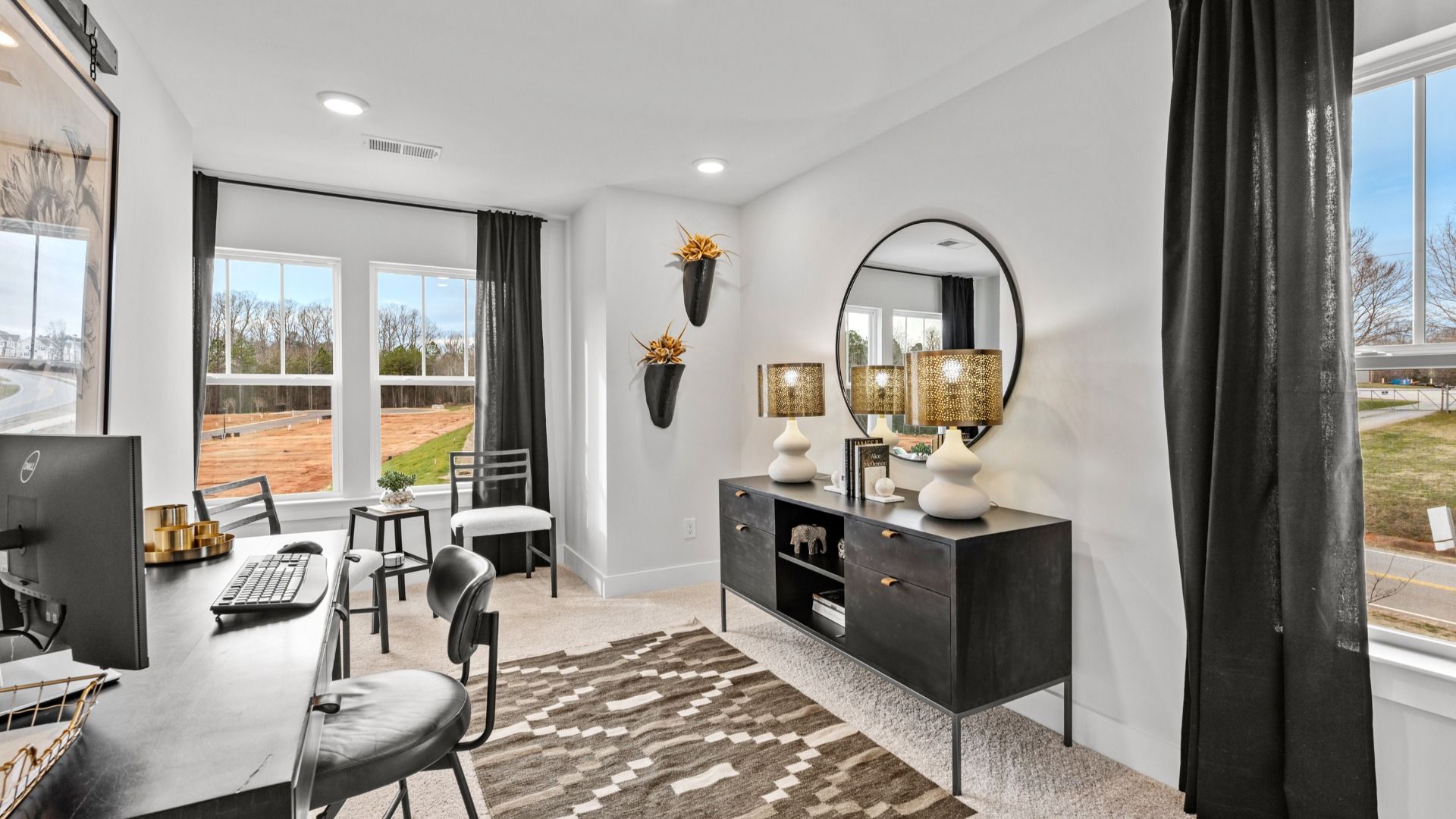 Study with plush carpet and large windows in two story townhome at Saluda Crossing by DRB Homes in Piedmont, SC