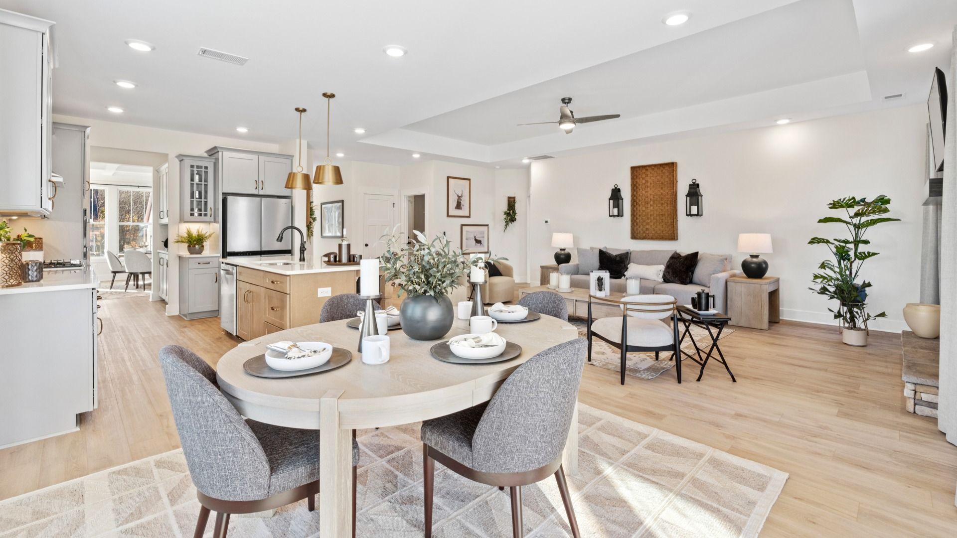 Modern farmhouse breakfast area adjacent from the kitchen and family room in open concept first floor living spaces