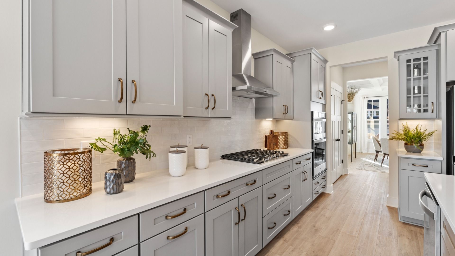 Modern kitchen with gold accents and light gray cabinetry giving a luxury feel at Fox Hollow by DRB Homes in Spartanburg, SC