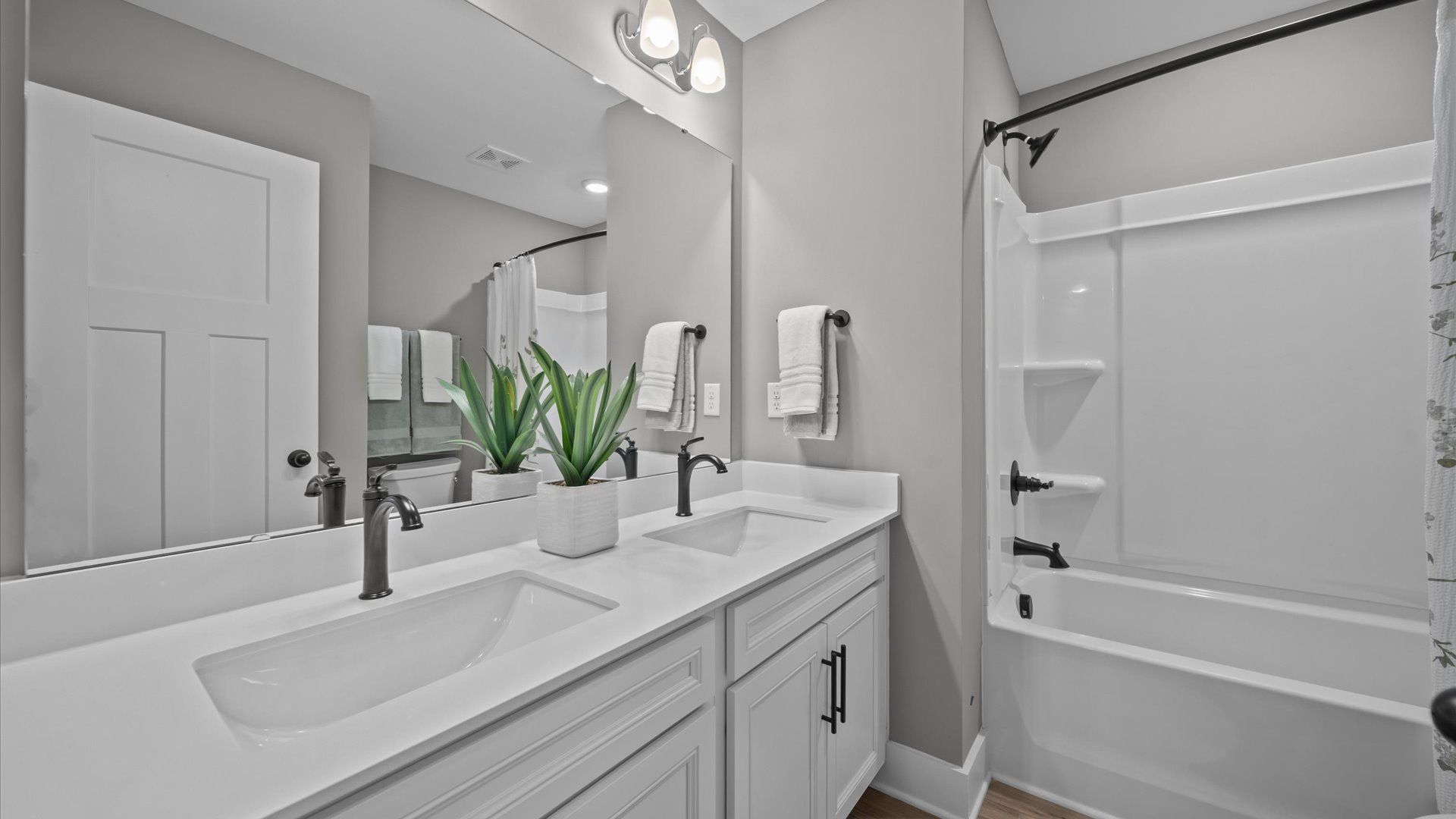 Tasteful bath with modern finishes and thoughtful double vanity layout