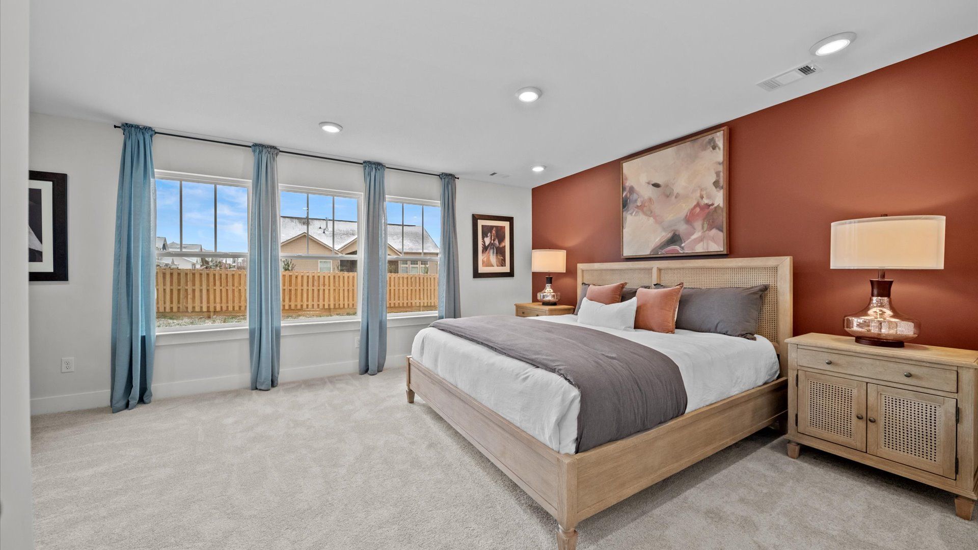 Vibrant natural light fills this exceptional primary bedroom with eye-catching details