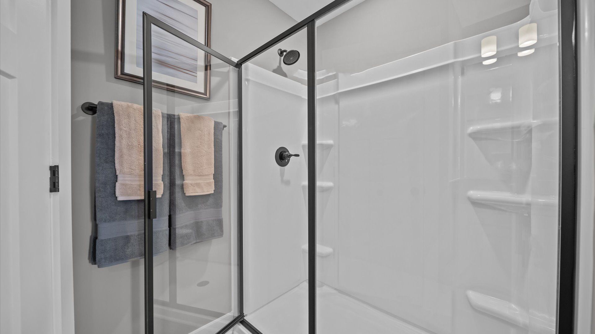 Superior en-suite primary bathroom with stylish dual vanity and walk-in shower—crafted with high standards in mind