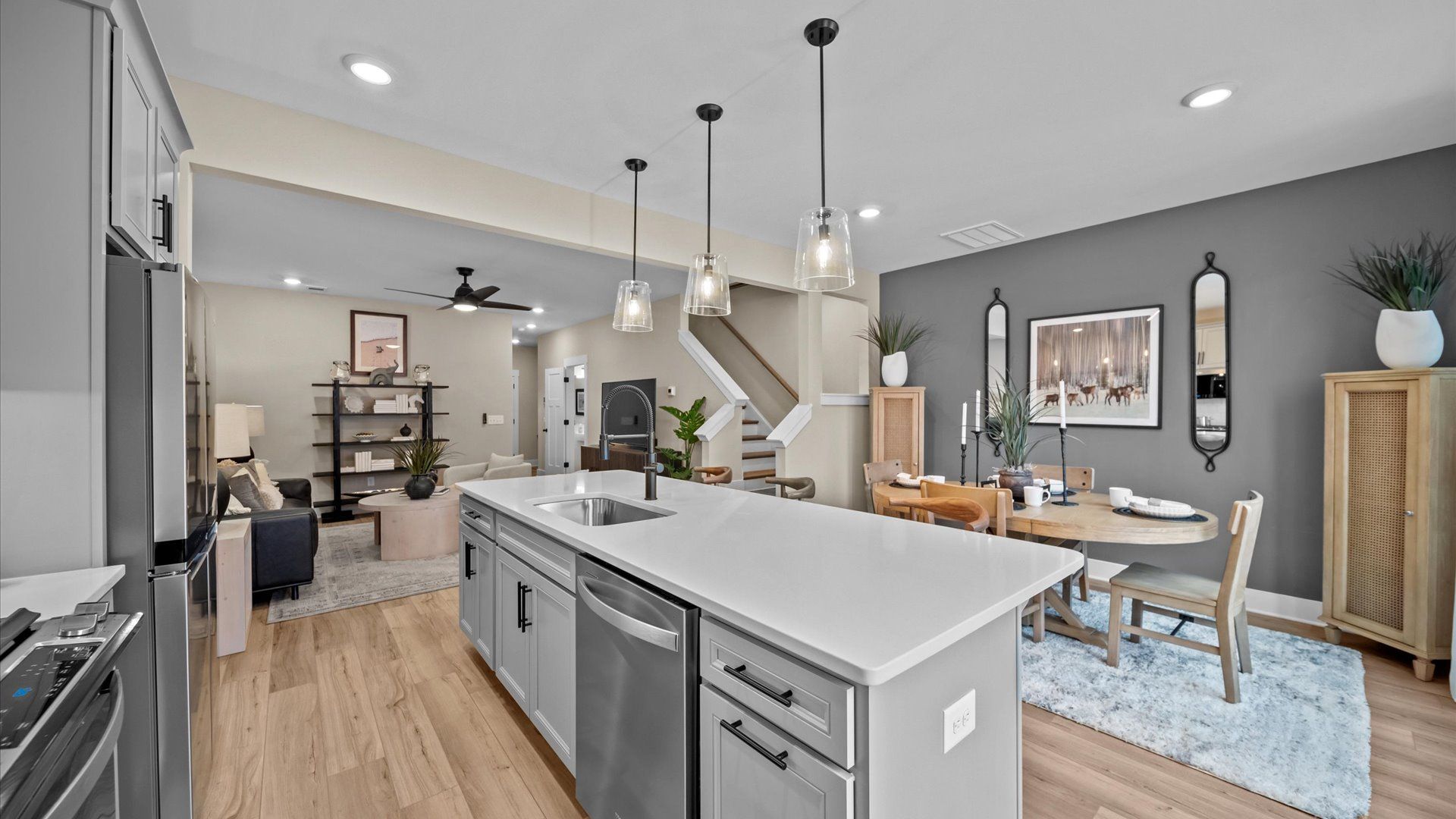 Tasteful design meets functional luxury in this kitchen with a 9-foot island and modern pendant lighting