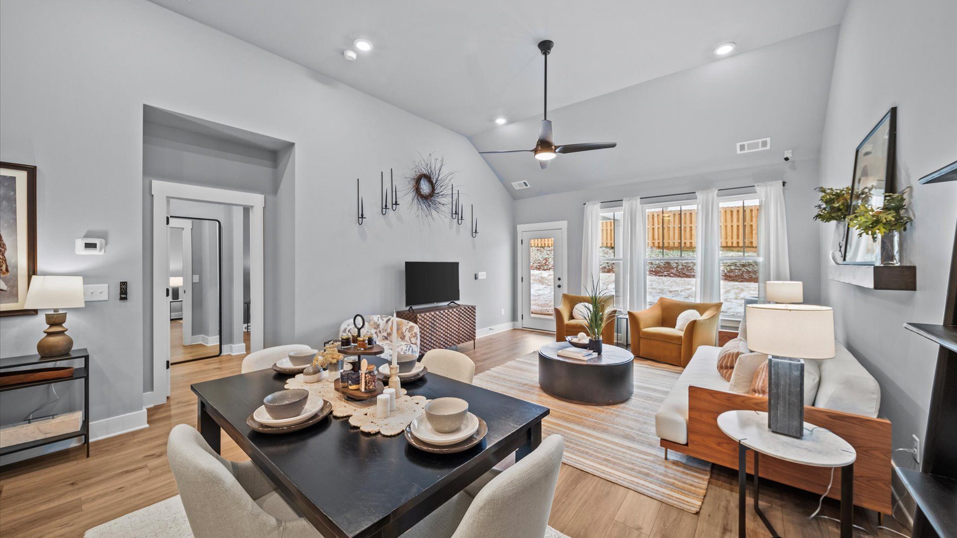 Spacious and stylish family room with two-story ceilings that create a bright and open atmosphere