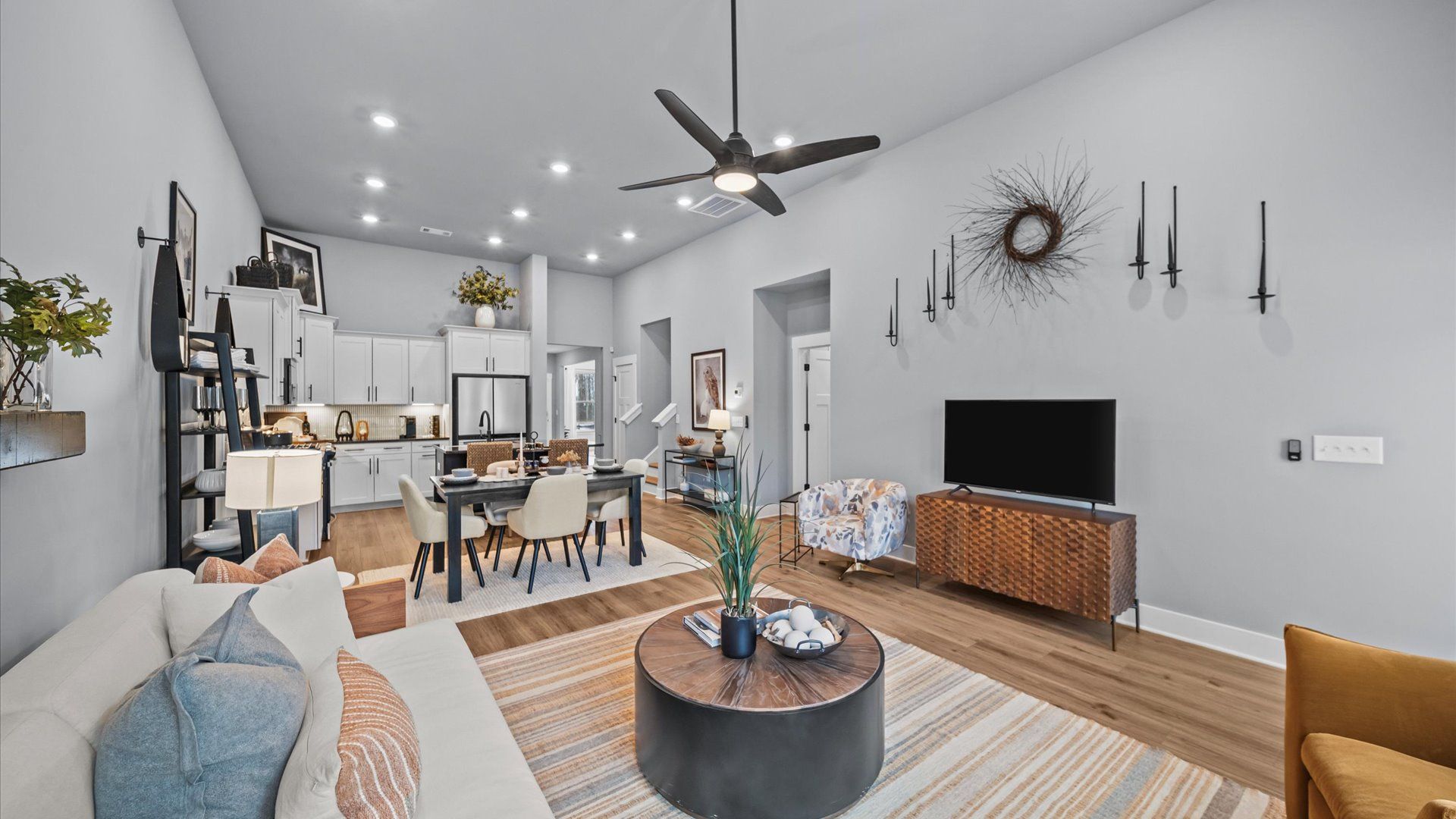 Eye-catching two-story family room with elegant trim, oversized windows, and elevated design