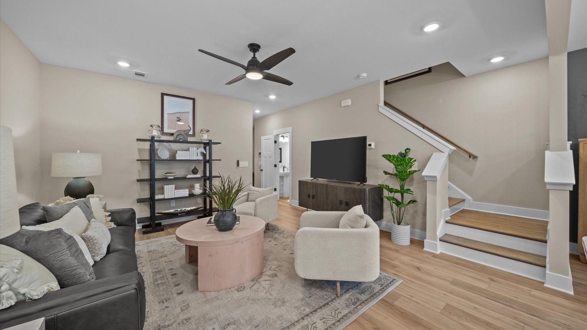 Family room with large windows, yard access, elevated ceilings, and LVP flooring at Aspen Ridge by DRB Homes in Lyman, SC