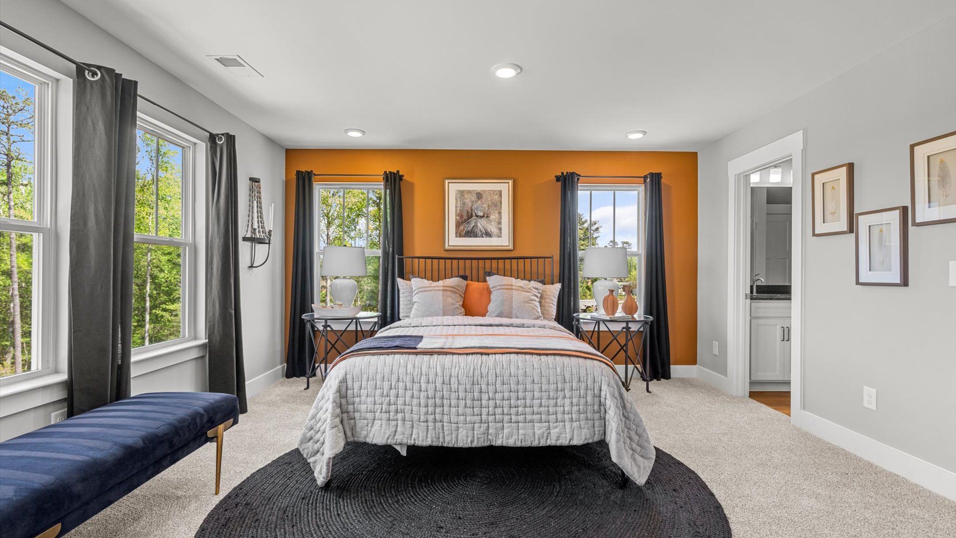 Spartanburg, SC two story townhome modern primary suite with large windows and plush carpet at Tyger Ridge